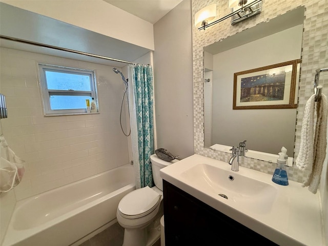 full bath featuring vanity, shower / bath combo with shower curtain, and toilet