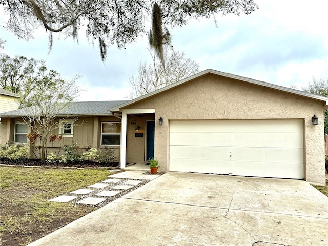 ranch-style home featuring driveway, an attached garage, and stucco siding