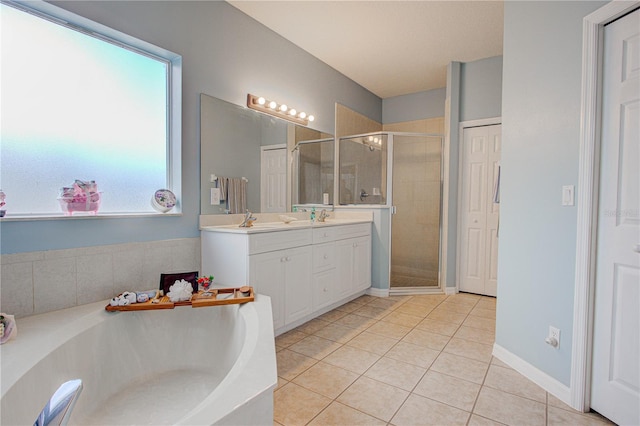 full bathroom with double vanity, a stall shower, a sink, a bath, and tile patterned floors