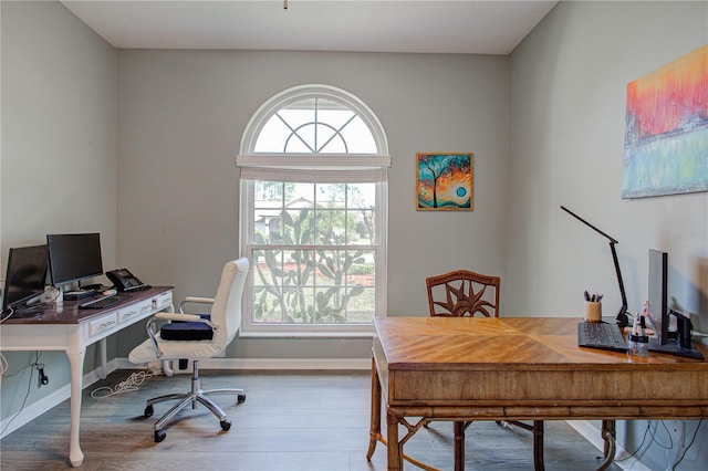 office area with baseboards and wood finished floors