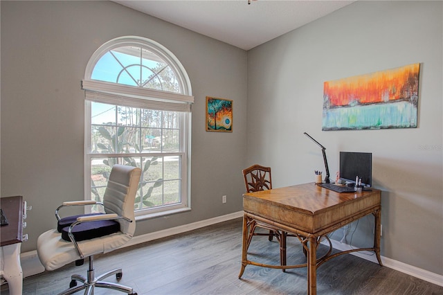 office space featuring baseboards and wood finished floors