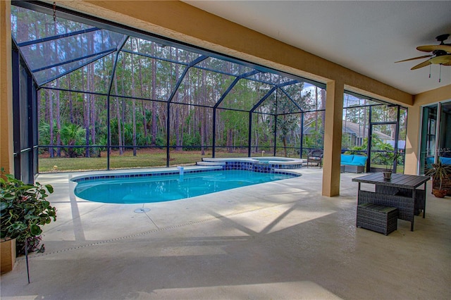 view of swimming pool with ceiling fan, glass enclosure, and a patio area