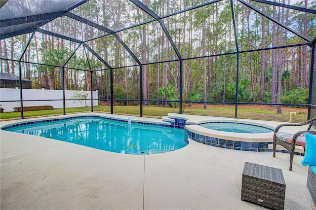 view of swimming pool with a patio area, a pool with connected hot tub, glass enclosure, and fence