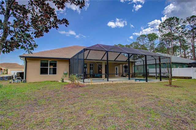 back of house featuring a lanai, fence, a fenced in pool, and a yard