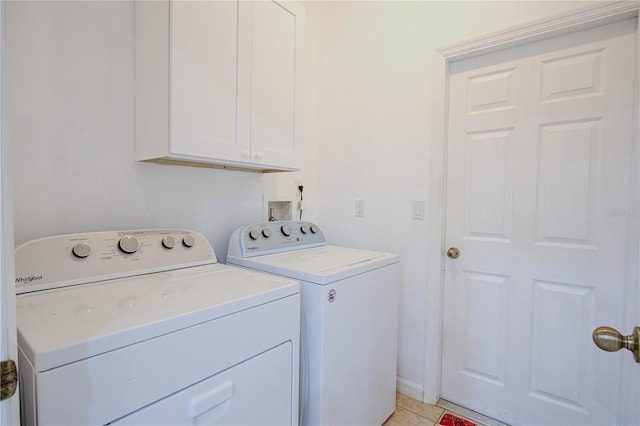 laundry room featuring cabinet space, independent washer and dryer, and light tile patterned floors