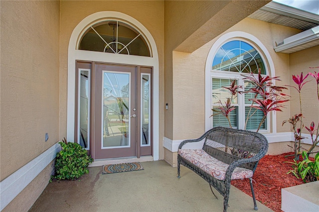 view of exterior entry with stucco siding