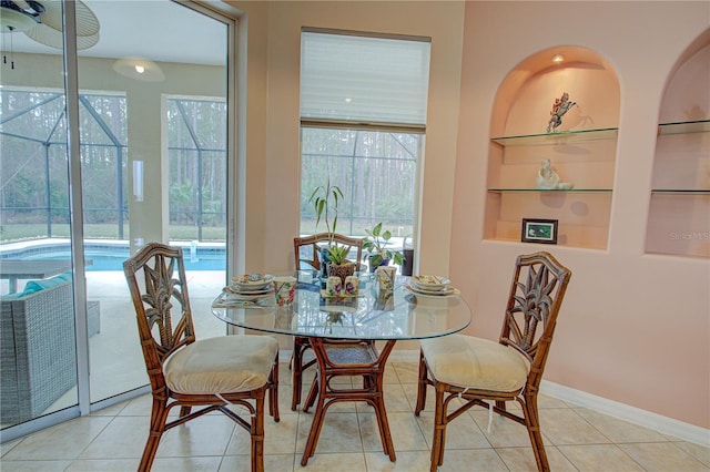 dining area featuring plenty of natural light, tile patterned flooring, and built in features