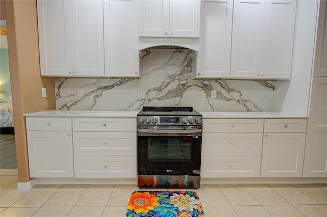 kitchen featuring white cabinets, electric range, light countertops, and backsplash