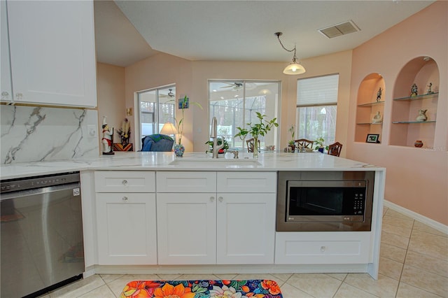 kitchen with white cabinets, visible vents, stainless steel appliances, and a sink