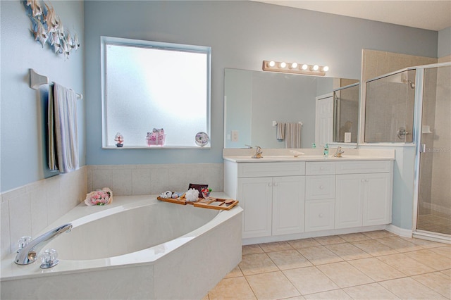 bathroom with a sink, a garden tub, a shower stall, and tile patterned flooring