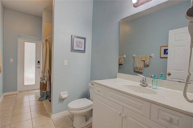 bathroom with baseboards, a shower with shower curtain, toilet, tile patterned flooring, and vanity