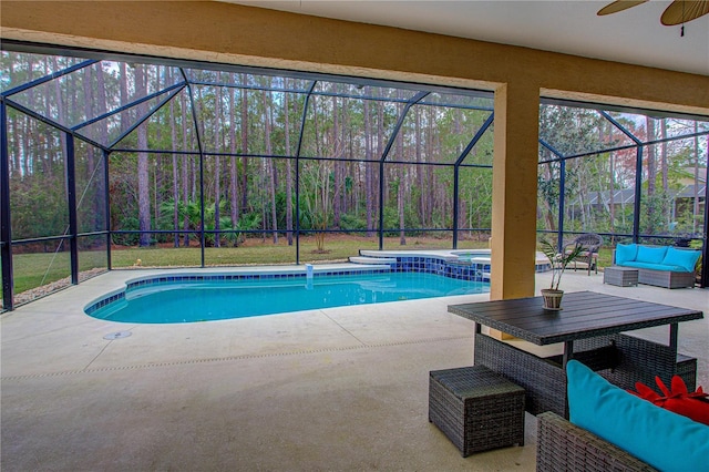 view of swimming pool with a patio, outdoor lounge area, glass enclosure, and a ceiling fan