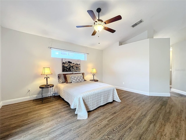 bedroom featuring vaulted ceiling, wood finished floors, visible vents, and baseboards