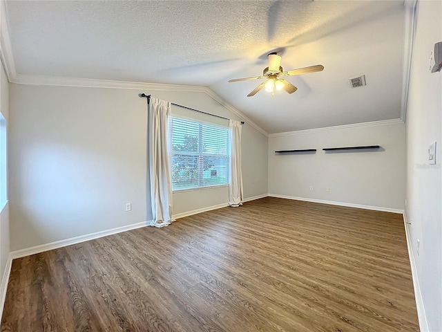 spare room featuring a textured ceiling, wood finished floors, visible vents, a ceiling fan, and ornamental molding