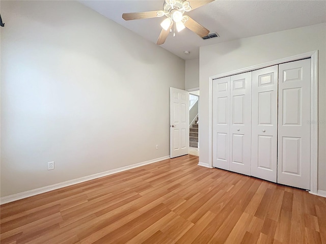 unfurnished bedroom with light wood finished floors, a closet, visible vents, ceiling fan, and baseboards