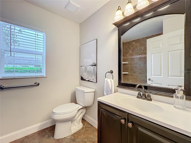 bathroom with visible vents, baseboards, toilet, tile patterned flooring, and a textured ceiling