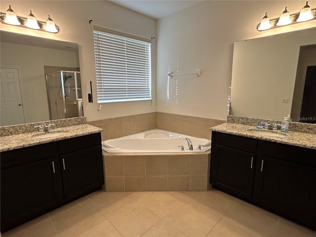bathroom featuring a garden tub, two vanities, a sink, tile patterned floors, and a stall shower