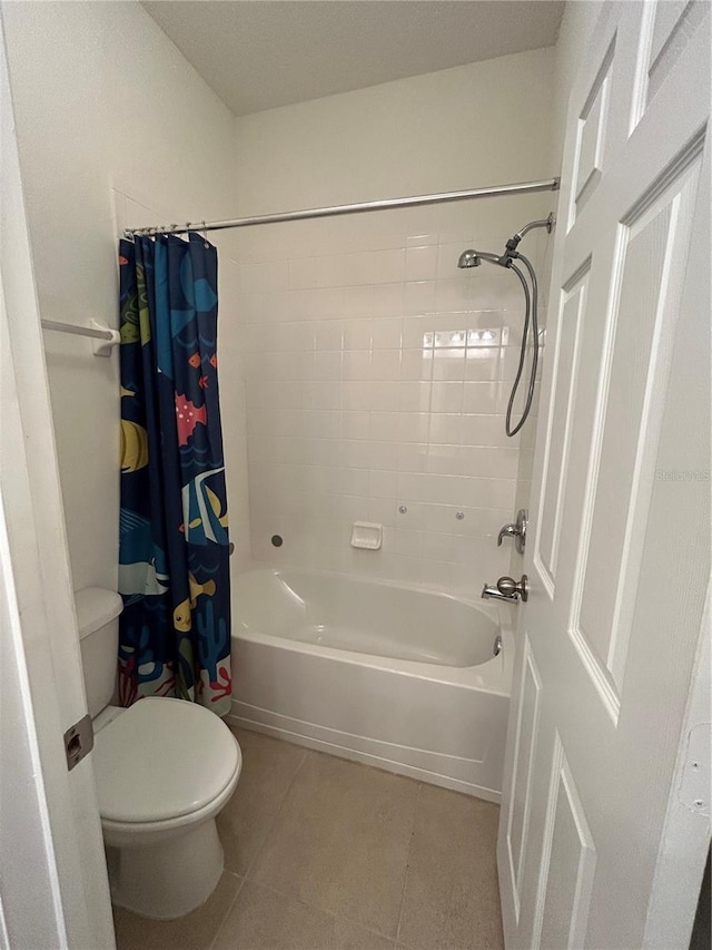full bathroom featuring shower / tub combo, toilet, and tile patterned floors