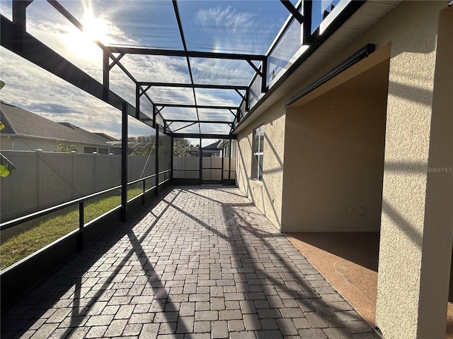 view of patio featuring a lanai and fence