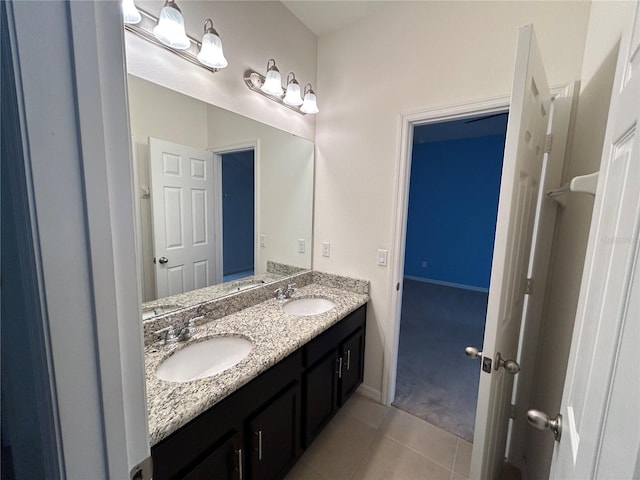 bathroom featuring double vanity, a sink, and tile patterned floors