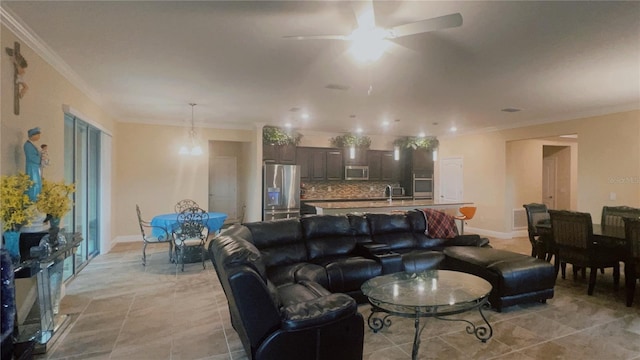 living area featuring baseboards, ornamental molding, and ceiling fan