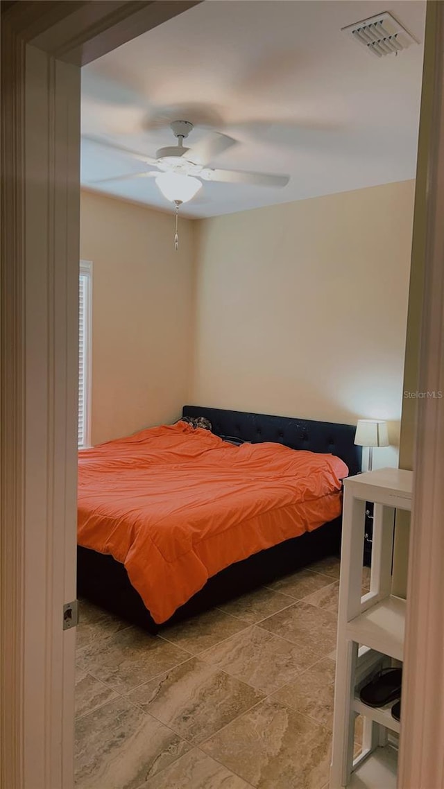 bedroom with visible vents and a ceiling fan