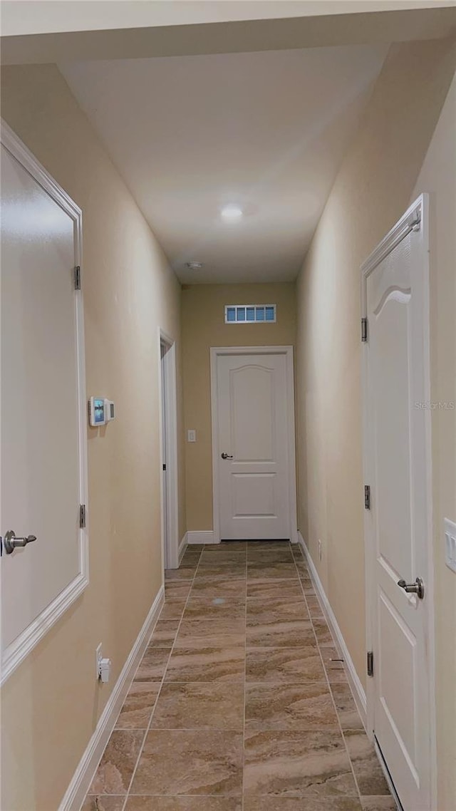 hall with visible vents and baseboards