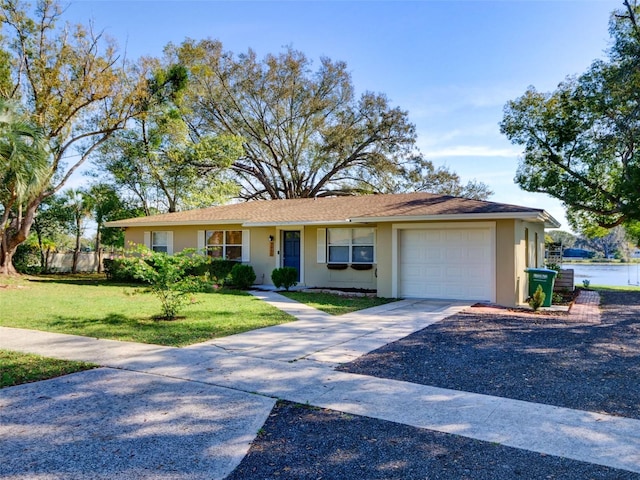 single story home with driveway, a garage, a front lawn, and stucco siding