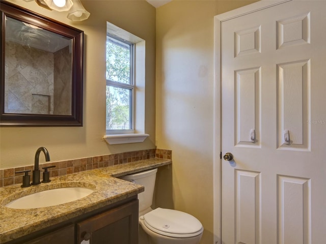 bathroom featuring toilet and vanity