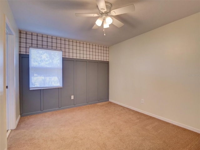 unfurnished bedroom featuring light carpet, baseboards, and wallpapered walls