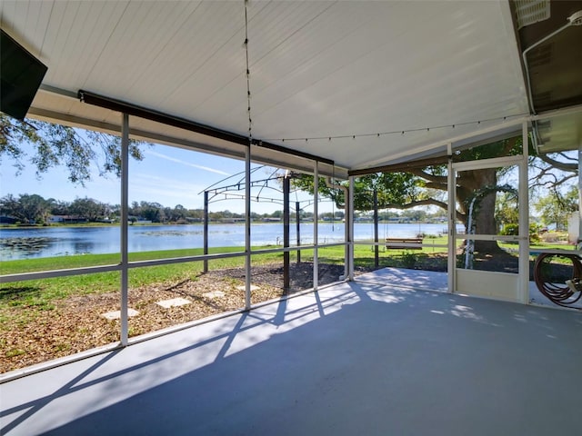 unfurnished sunroom featuring a water view