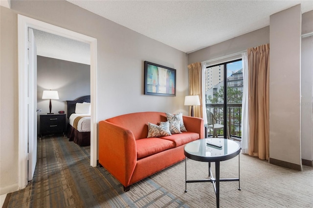 interior space featuring baseboards, a textured ceiling, and carpet floors