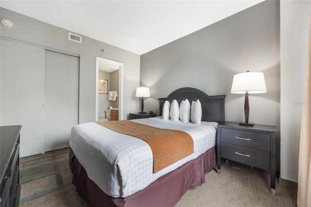 bedroom featuring visible vents, carpet floors, and a closet