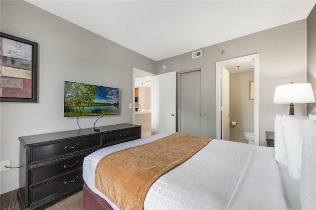 bedroom with visible vents and ensuite bath