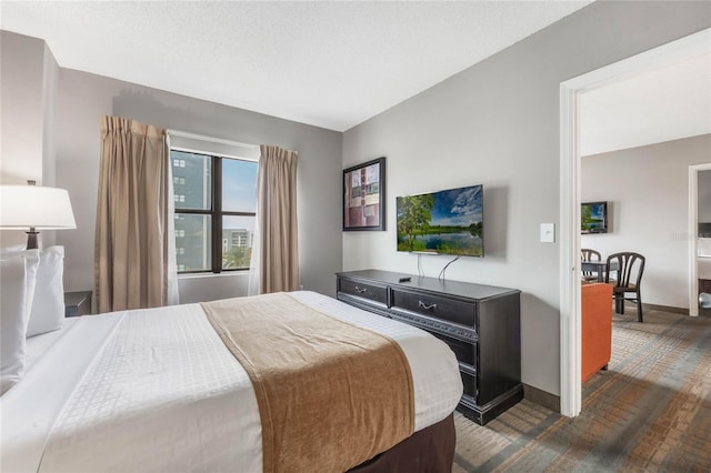 bedroom featuring baseboards and a textured ceiling