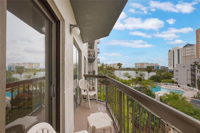 balcony featuring a view of city and a water view