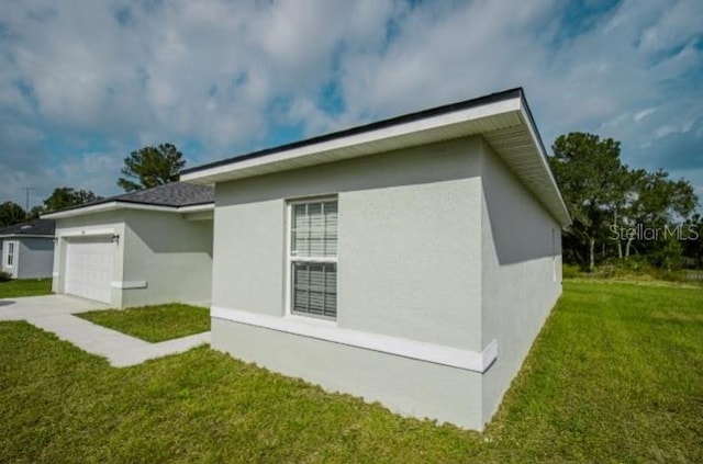 view of property exterior with a lawn, driveway, a garage, and stucco siding