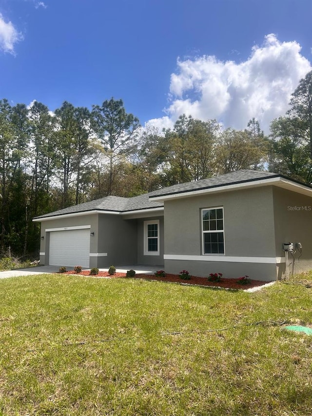 9451 N Emellia Ave, Citrus Springs, FL 34433 - ranch-style home featuring stucco siding, an attached garage, a front lawn, and driveway