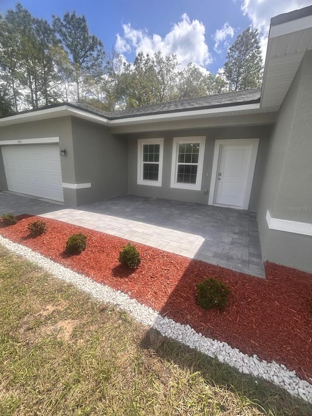 9451 N Emellia Ave, Citrus Springs, FL 34433 - entrance to property featuring stucco siding and a garage