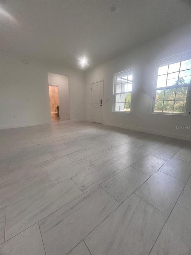 9451 N Emellia Ave, Citrus Springs, FL 34433 - spare room featuring baseboards and light marble finish floors