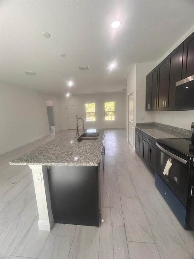 9451 N Emellia Ave, Citrus Springs, FL 34433 - kitchen featuring a sink, black range with electric cooktop, light marble finish floors, open floor plan, and light stone countertops