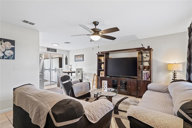 living room featuring a ceiling fan, visible vents, and light tile patterned floors