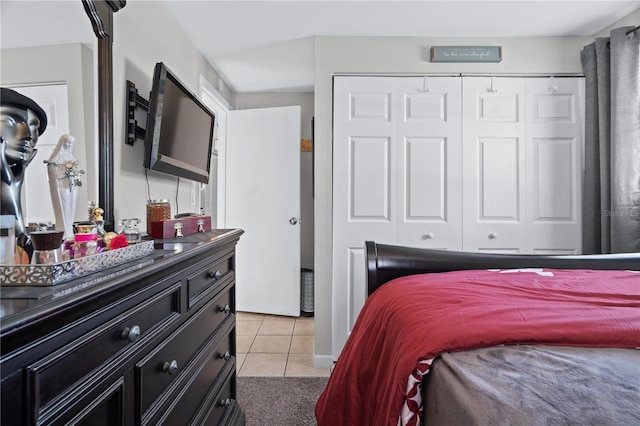 bedroom with a closet and light tile patterned flooring