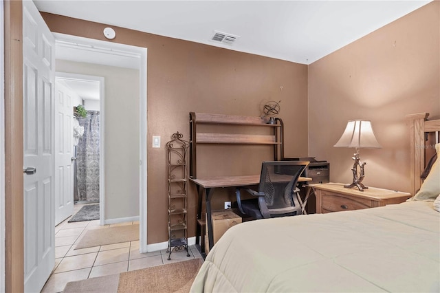 bedroom with light tile patterned flooring, visible vents, and baseboards