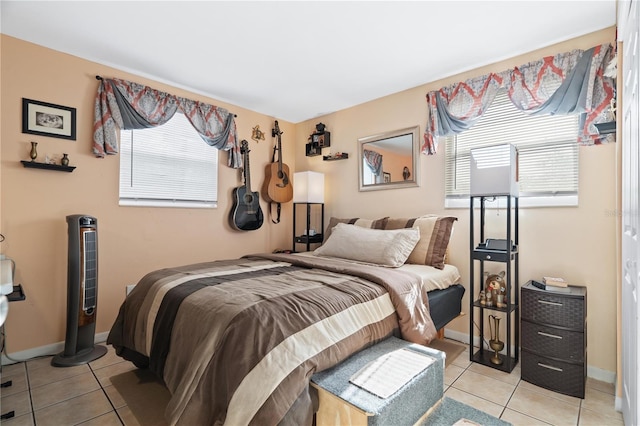 bedroom featuring light tile patterned flooring and baseboards