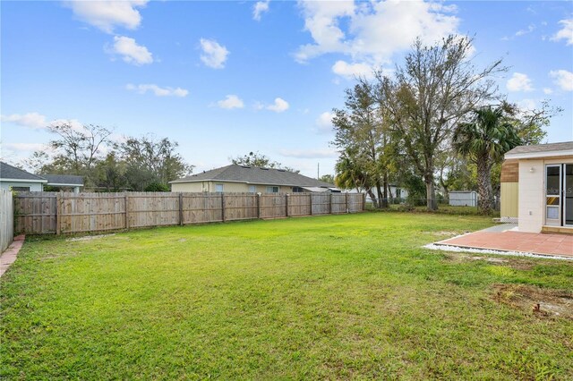 view of yard with a fenced backyard and a patio