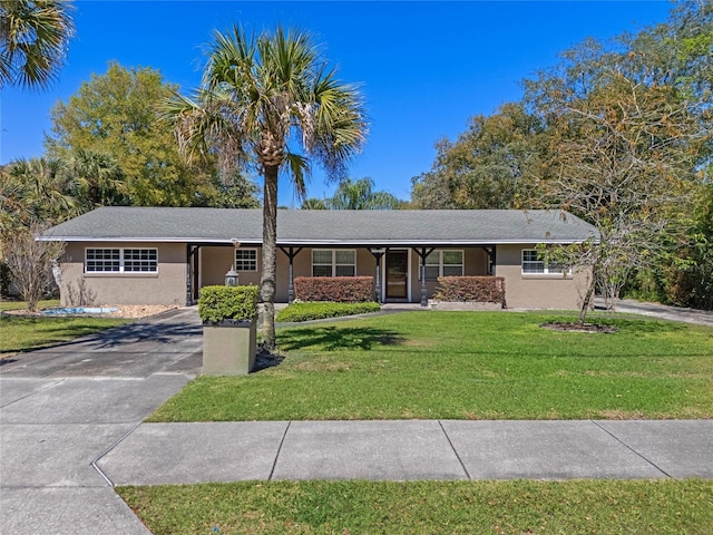 ranch-style house with stucco siding, concrete driveway, and a front yard