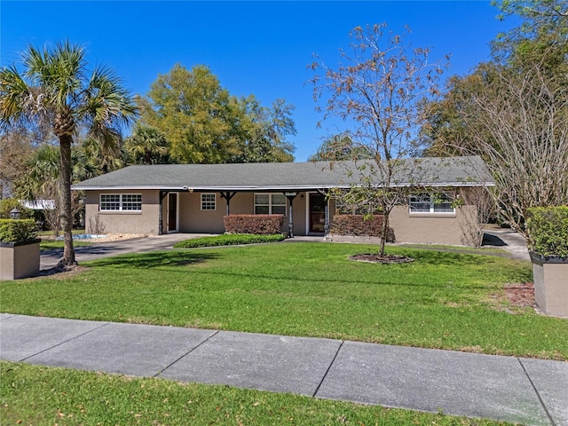 single story home with a front yard and stucco siding