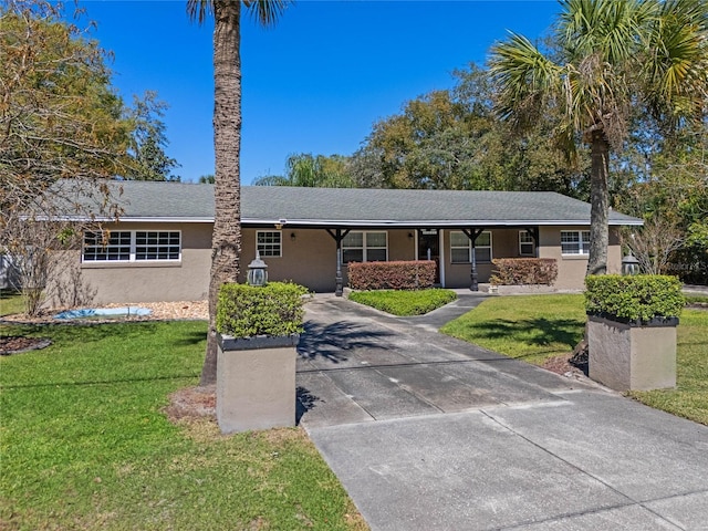 single story home featuring stucco siding, driveway, and a front yard