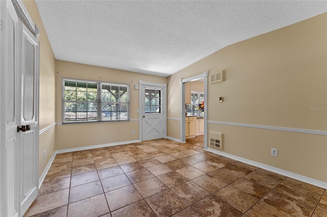 entryway featuring visible vents, baseboards, and a textured ceiling